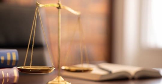 justice scales and law books on desk